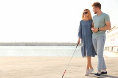 Young man helping blind person with long cane in city royalty free stock photo Young man helping blind person with long cane in city royalty free stock photo