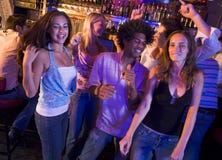 Young men and women dancing in a nightclub