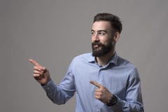 Young modern stylish bearded millennial business man showing fingers presenting blank copyspace Royalty Free Stock Photo Young modern stylish bearded millennial business man showing fingers presenting blank copyspace Royalty Free Stock Photo