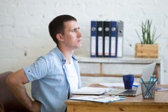 Young office man suffering from backache stock photos Young office man suffering from backache stock photos