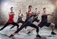 Young people doing workout with elastic band royalty free stock image Young people doing workout with elastic band royalty free stock image