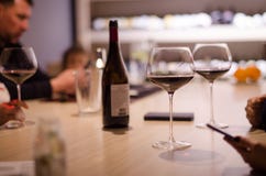 Young people drink red wine from beautiful glasses in a restaurant stock photography Young people drink red wine from beautiful glasses in a restaurant stock photography