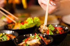 Young people eating in Thai restaurant royalty free stock photos Young people eating in Thai restaurant royalty free stock photos