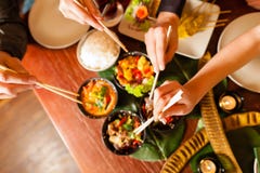 Young people eating in Thai restaurant Stock Photo Young people eating in Thai restaurant Stock Photo