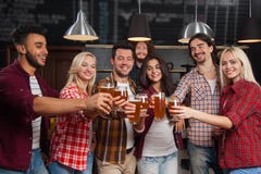 Young People Group In Bar Toasting, Hold Beer Glasses, Friends Cheers Standing At Pub, Happy Smiling Stock Photography Young People Group In Bar Toasting, Hold Beer Glasses, Friends Cheers Standing At Pub, Happy Smiling Stock Photography