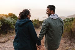 Young people walking through the country path stock image Young people walking through the country path stock image