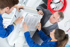 Young people woking on air conditioning unit Royalty Free Stock Photos Young people woking on air conditioning unit Royalty Free Stock Photos
