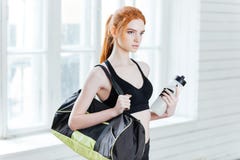 Young pretty fitness woman with sports bag and water bottle stock photos Young pretty fitness woman with sports bag and water bottle stock photos