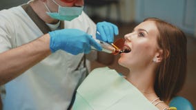 Young pretty girl is in dental cabinet on treatment and dental cleansing. 4K stock video Young pretty girl is in dental cabinet on treatment and dental cleansing. 4K stock video