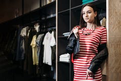 The young pretty woman choosing, trying and buys dresses at shop clothing. Banner for online store clothing stock photos The young pretty woman choosing, trying and buys dresses at shop clothing. Banner for online store clothing stock photos