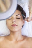Young pretty woman getting cosmetic injection in the face like a stock photo Young pretty woman getting cosmetic injection in the face like a stock photo