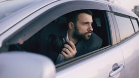 Young private detective man sitting inside car and photographing with dslr camera royalty free stock images Young private detective man sitting inside car and photographing with dslr camera royalty free stock images