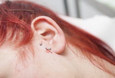Young red-haired girl with piercing jewel just after to be pierced on ear skin royalty free stock images Young red-haired girl with piercing jewel just after to be pierced on ear skin royalty free stock images