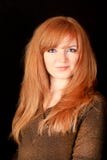 Young Red-haired Girl Smiling On A Dark Background Royalty Free Stock Photography Young Red-haired Girl Smiling On A Dark Background Royalty Free Stock Photography