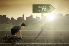 Young runner with healthy life on signpost stock images Young runner with healthy life on signpost stock images