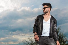 Young man in leather jacket and sunglasses standing outdoor royalty free stock photos Young man in leather jacket and sunglasses standing outdoor royalty free stock photos