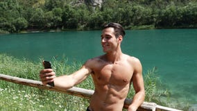 Man taking selfie at lake