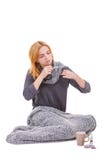 A sick girl sits next to the medicines and measures the temperature with a thermometer. Isolated. royalty free stock images A sick girl sits next to the medicines and measures the temperature with a thermometer. Isolated. royalty free stock images