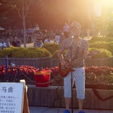 Young singer singing in sunset