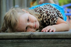 Young smiling child lying down at the playground royalty free stock image Young smiling child lying down at the playground royalty free stock image