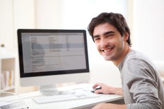 Young Smiling Man In Front Of Computer Stock Image