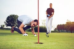 Young sportive couple playing golf on a golf course royalty free stock images Young sportive couple playing golf on a golf course royalty free stock images