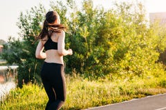 Young sports woman engaged in summer morning running in Park on an asphalt treadmill. concept healthy lifestyle stock image Young sports woman engaged in summer morning running in Park on an asphalt treadmill. concept healthy lifestyle stock image