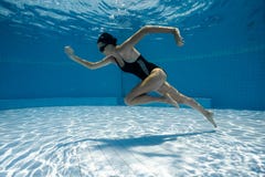 Young Sporty Woman Running Underwater. Stock Images
