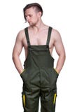 Young strong man with a naked torso in a working uniform stuck h royalty free stock photos Young strong man with a naked torso in a working uniform stuck h royalty free stock photos