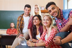 Young Students Group Using Tablet Computer, Mixed Race People Smiling Looking To Camera royalty free stock photos Young Students Group Using Tablet Computer, Mixed Race People Smiling Looking To Camera royalty free stock photos