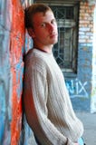 Young Stylish Man Stand Near Graffiti Brick Wall. Stock Photography