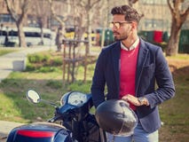 Trendy man by scooter in city Stock Image Trendy man by scooter in city Stock Image