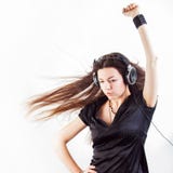 Young stylish woman in large headphones listening to music and having fun. stock images Young stylish woman in large headphones listening to music and having fun. stock images