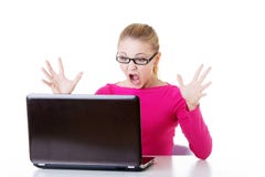 Young surprised woman sitting in front of laptop. Royalty Free Stock Photo Young surprised woman sitting in front of laptop. Royalty Free Stock Photo
