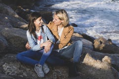 Young teenage girl with her mother in affectionate gesture by the sea. Family vacations on the coast stock images Young teenage girl with her mother in affectionate gesture by the sea. Family vacations on the coast stock images