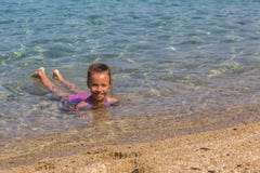 Young tourist girl is swimming in Aegean Sea on the coast of the Sithonia Peninsula Stock Photography Young tourist girl is swimming in Aegean Sea on the coast of the Sithonia Peninsula Stock Photography