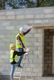 Young trainee woman with her tutor on a construction site visit, building trades royalty free stock image Young trainee woman with her tutor on a construction site visit, building trades royalty free stock image