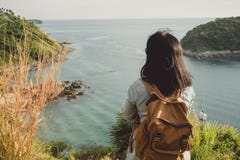Young traveler woman standing and looking at view enjoying a bea Stock Image Young traveler woman standing and looking at view enjoying a bea Stock Image