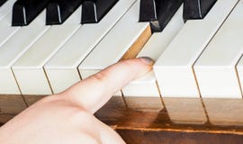 Young Unrecognizable Girl Child, Playing Piano Stock Image