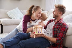 Young white family playing together in sitting room royalty free stock image Young white family playing together in sitting room royalty free stock image