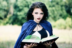 Young Witch With A Book Stock Photos