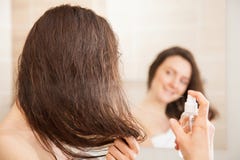Young woman applying hair spray royalty free stock photo Young woman applying hair spray royalty free stock photo