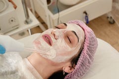 Young woman in beauty salon does rejuvenating, toning procedure darsonval on the face stock photos Young woman in beauty salon does rejuvenating, toning procedure darsonval on the face stock photos