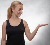 Young woman in black tank top with open hand royalty free stock image Young woman in black tank top with open hand royalty free stock image
