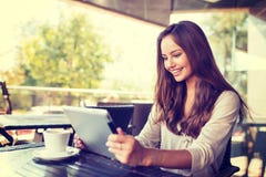 Young woman in cafe using tablet royalty free stock photos Young woman in cafe using tablet royalty free stock photos