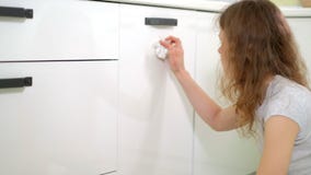 Young woman cleaning with duster at kitchen at home stock video Young woman cleaning with duster at kitchen at home stock video