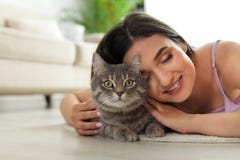 Young woman with cute cat at home. Pet and owner royalty free stock photo Young woman with cute cat at home. Pet and owner royalty free stock photo