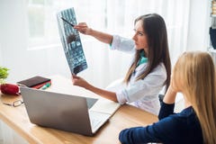 Young woman doctor watching a patient x-ray in hospital. stock images Young woman doctor watching a patient x-ray in hospital. stock images