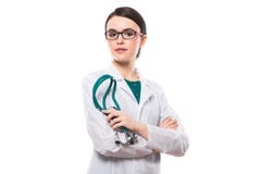 Young Woman Doctor With Crossed Arms Holding Stethoscope In Her Hand In White Uniform On White Background Stock Photos Young Woman Doctor With Crossed Arms Holding Stethoscope In Her Hand In White Uniform On White Background Stock Photos