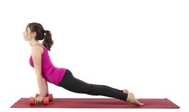 Young woman doing upward facing dog with dumbbells Stock Photo Young woman doing upward facing dog with dumbbells Stock Photo